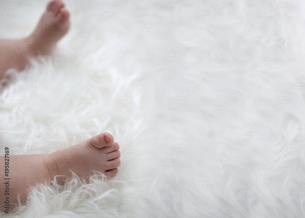 baby feet on white blanket. copy space. selective focus baby feet on white blanket. copy space. selective focus