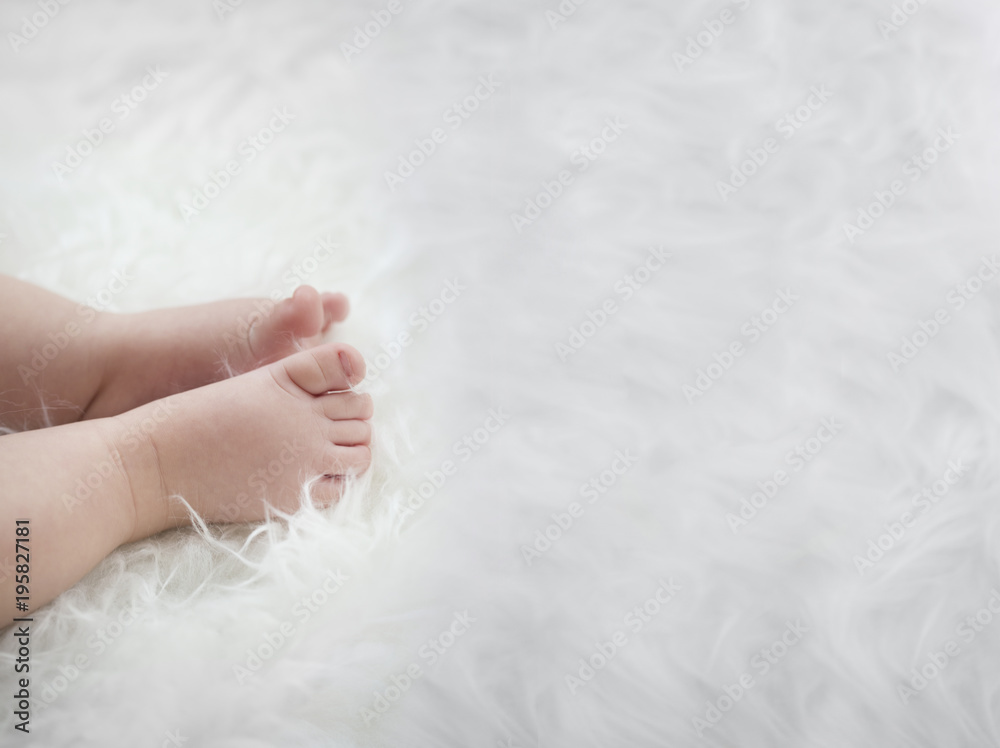 baby feet on white blanket. copy space. selective focus