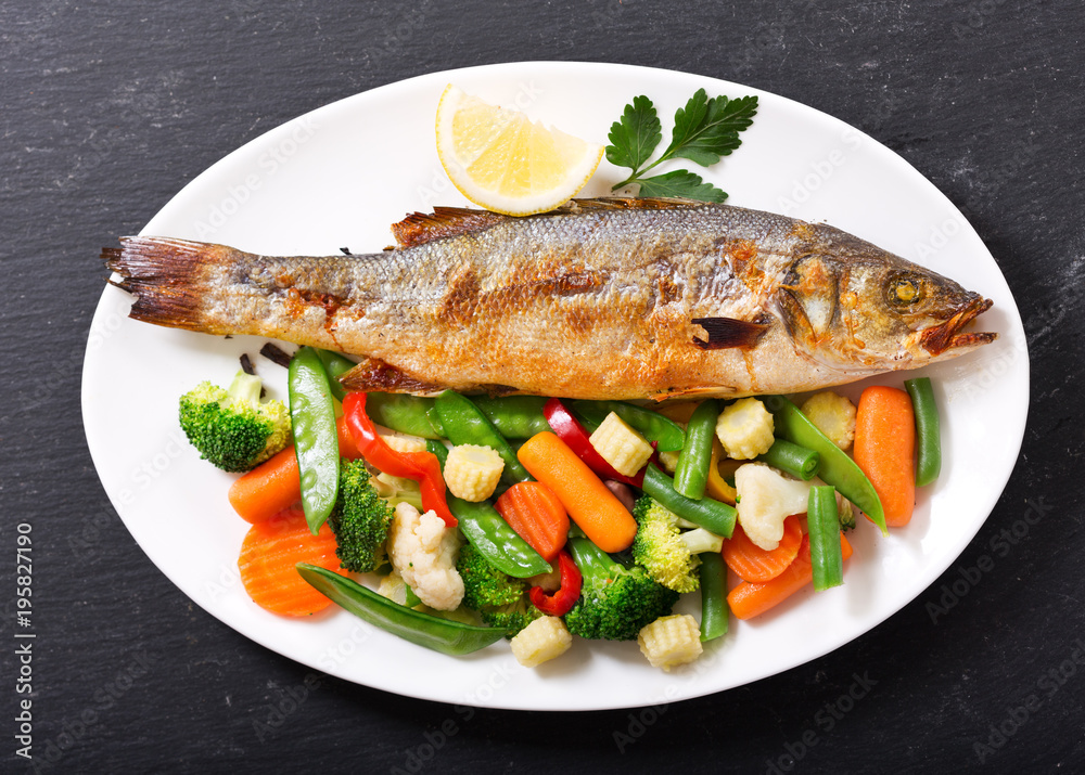 plate of baked fish with vegetables plate of baked fish with vegetables