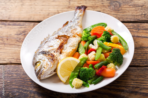 plate of baked fish with vegetables