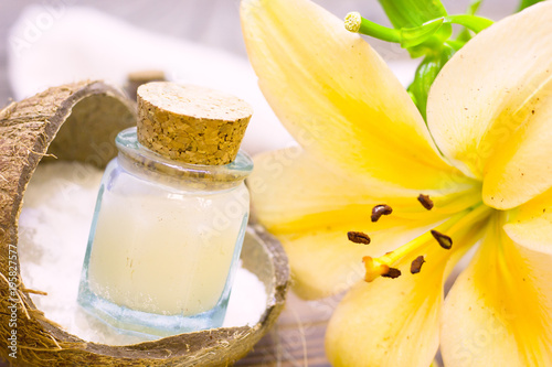 Natural herbal skin care products  top view ingredients coconut  lily flower  essence oil on table concept of the best all natural face moisturizer. Facial treatment preparation background