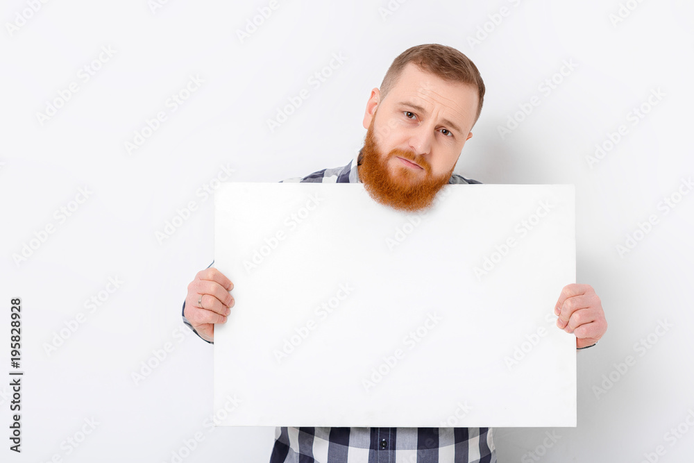 man with beard holding big white card. man with beard holding big white card.
