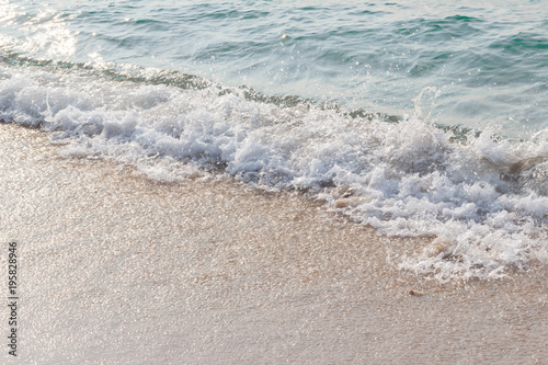 Sea waves hit the beach Light falls on the surface of the sea Beach with sunlight