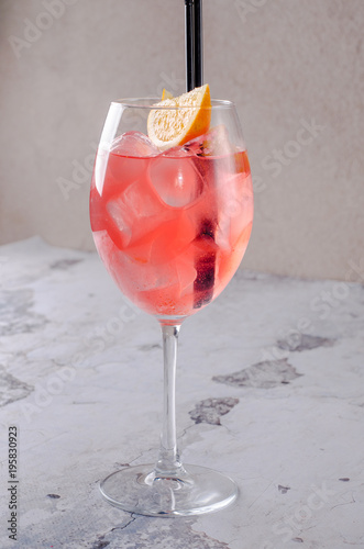 Classic Italian Aperol Spritz cocktail consisting of prosecco, aperitif and soda water with orange slice fresh fruit in wineglass on background. Exotic red summer drink. Bar alcohol menu
