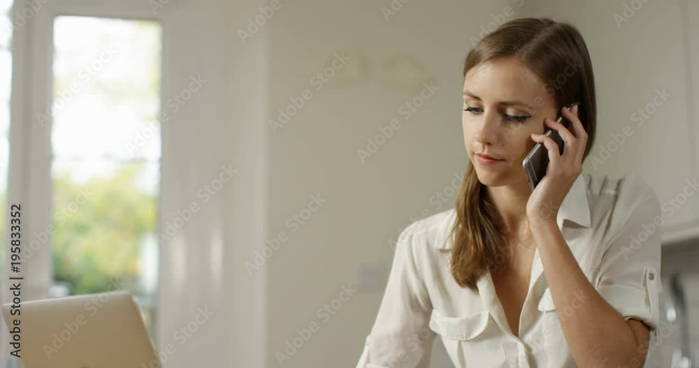 4K Cheerful businesswoman making a friendly phone call at her desk. Slow motion. 4K Cheerful businesswoman making a friendly phone call at her desk. Slow motion.