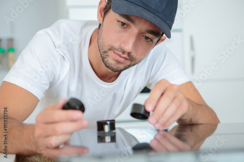 Workman holding black objects