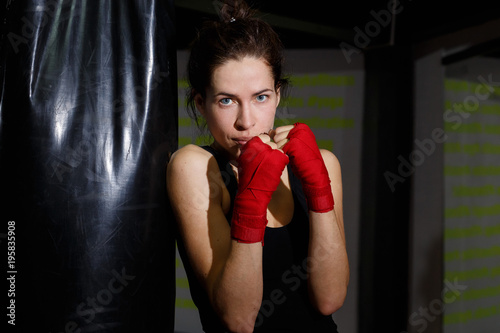 thin girl at a boxing training in a gym