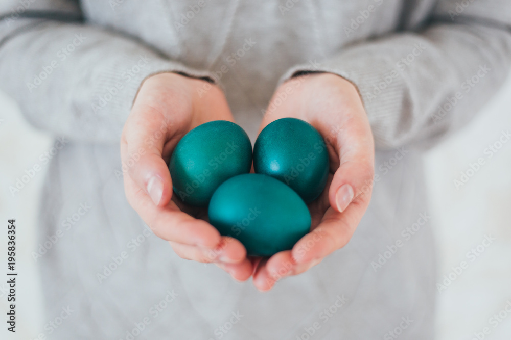 Beautiful woman hands holden blue easter egg with perfect nails can be used as background Beautiful woman hands holden blue easter egg with perfect nails can be used as background