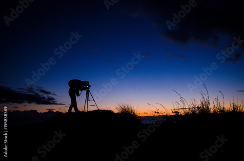 Silhouette photographer on the beach during sunset