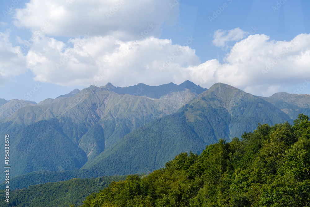 Scenic mountainous area against blue sky with clouds