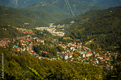 Photo of buildings at foot of mountains