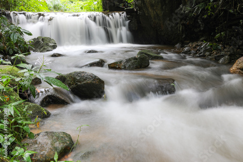 Fototapeta Naklejka Na Ścianę i Meble -  Water in stream is small waterfall.