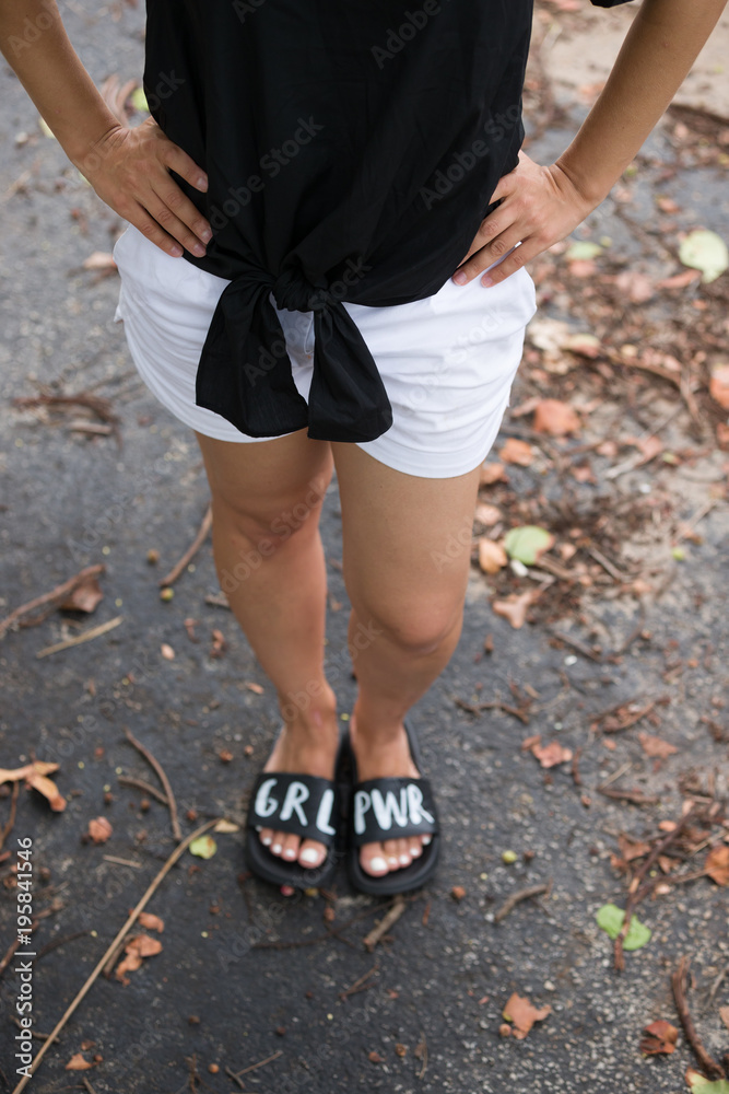 Closeup of woman's legs. Girl standing on a road.