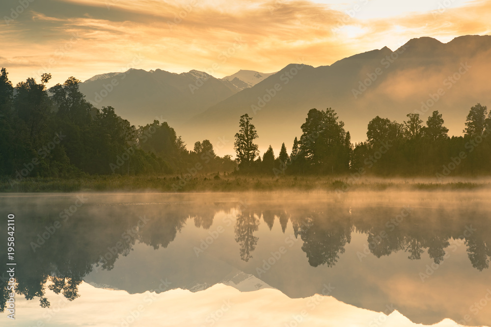 Naklejka premium Beautiful mirror water Matheson lake in morning, New Zealand natural landscape background