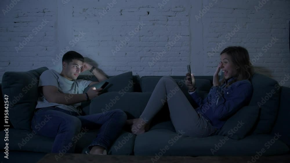 boyfriend using relaxed mobile pone gets jealous and upset when his girlfriend gets a video call from a friend boyfriend using relaxed mobile pone gets jealous and upset when his girlfriend gets a video call from a friend