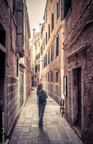 Girl tourist is on a narrow street in Venice, Italy © scaliger