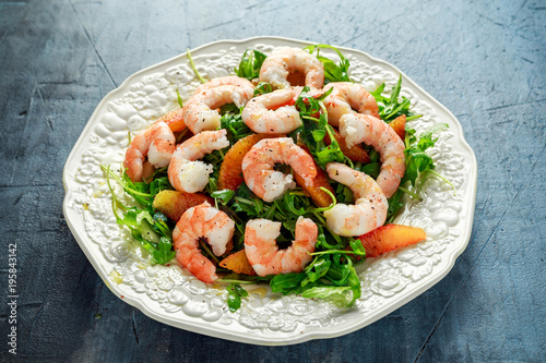 Asian style shrimp salad with wild rocket and blood orange served with lemon wedges and balsamic vinegar drizzle