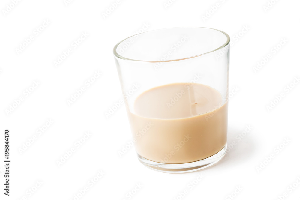 slanted glass tumbler with cream liqueur isolated on white slanted glass tumbler with cream liqueur isolated on white