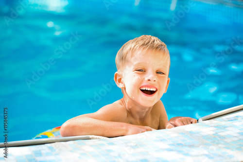 Boy floating on an inflatable circle in the pool