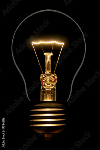Photo of silhouette of incandescent filament bulbs on a black background. Detail of a lit European bulb. Product photo flashbulb.