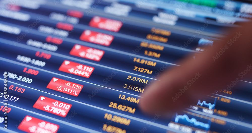 Finger touch on digital tablet computer with stock market graph Finger touch on digital tablet computer with stock market graph