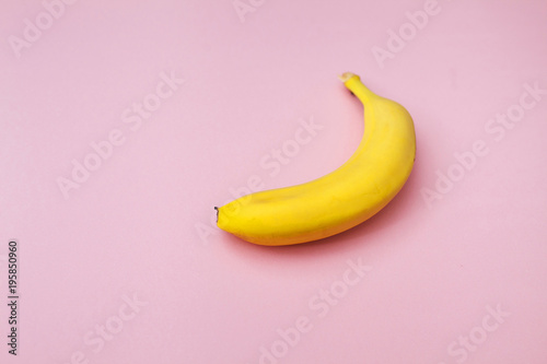 ripe yellow banana on a pink background