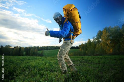 man with backpack, tourist, brutal journey, hike, the concept of active male recreation, portrait of a severe, brutal man, guy preparing equipment for the mountains