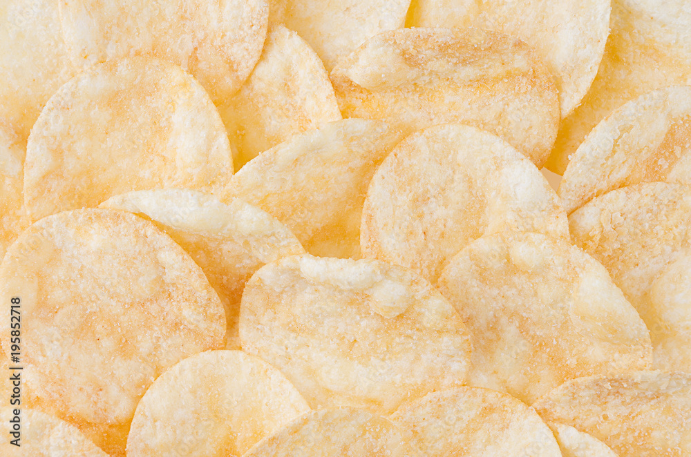 Crunchy golden potato chips pattern, top view, background.