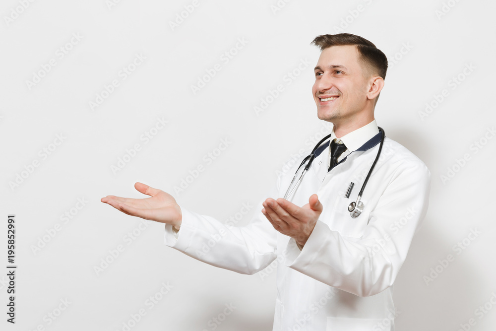 Smiling happy young doctor man isolated on white background. Male doctor in medical uniform, stethoscope looking aside, spreading hands for greeting. Healthcare personnel, health, medicine concept. Smiling happy young doctor man isolated on white background. Male doctor in medical uniform, stethoscope looking aside, spreading hands for greeting. Healthcare personnel, health, medicine concept.
