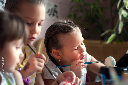 Schoolchildren painting eggs for Easter