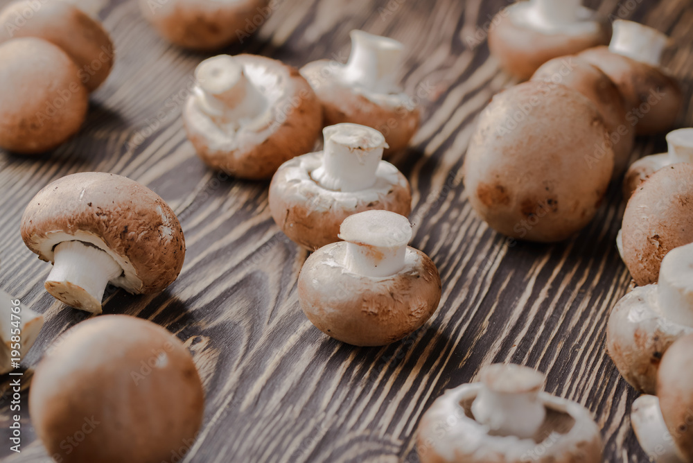 mushrooms champignons on a wooden background mushrooms champignons on a wooden background