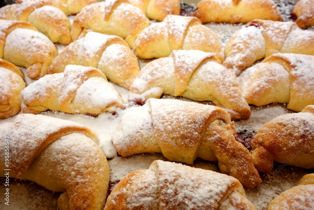 Little homemade fruit croissants with powdered sugar, close-up