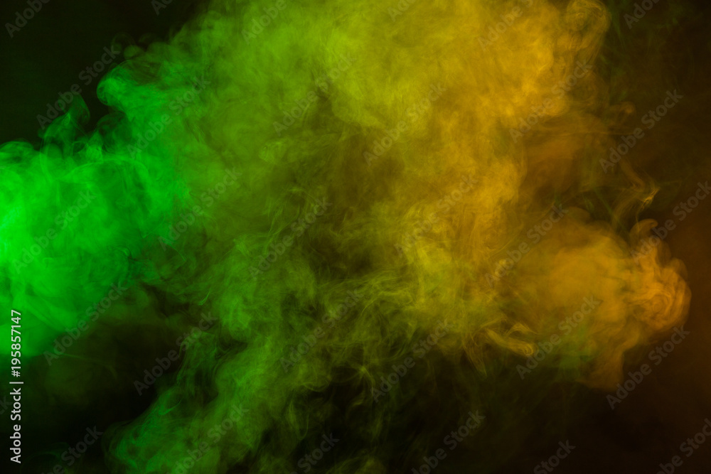 Green and yellow smoke in dark background. Texture and desktop picture