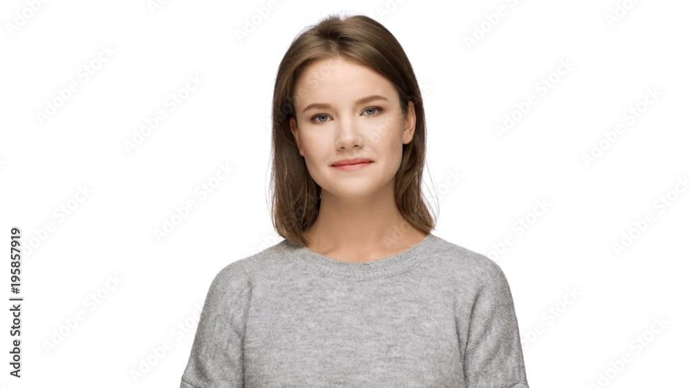 Portrait of affable brunette lady expressing agreement while nodding positively and meaning yes with body language, over white background. Concept of emotions Portrait of affable brunette lady expressing agreement while nodding positively and meaning yes with body language, over white background. Concept of emotions