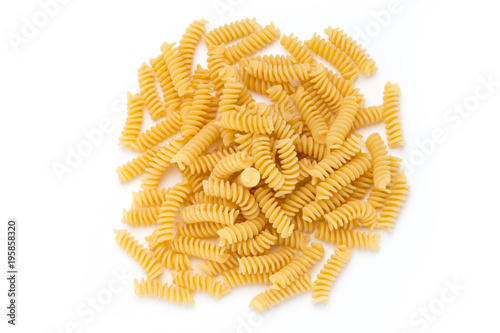 Uncooked fusilli pasta isolated white background.