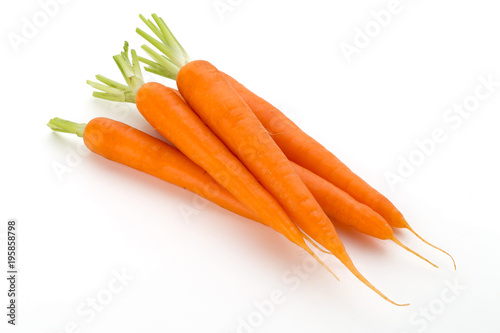 Carrot vegetable with leaves on the wooden background.