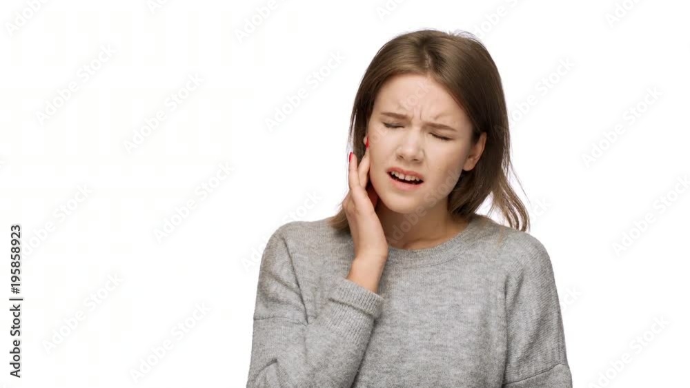 Portrait of pretty woman with long hair suffering from toothache with touching cheek while expressing pain on face, over white background in studio. Concept of emotions Portrait of pretty woman with long hair suffering from toothache with touching cheek while expressing pain on face, over white background in studio. Concept of emotions