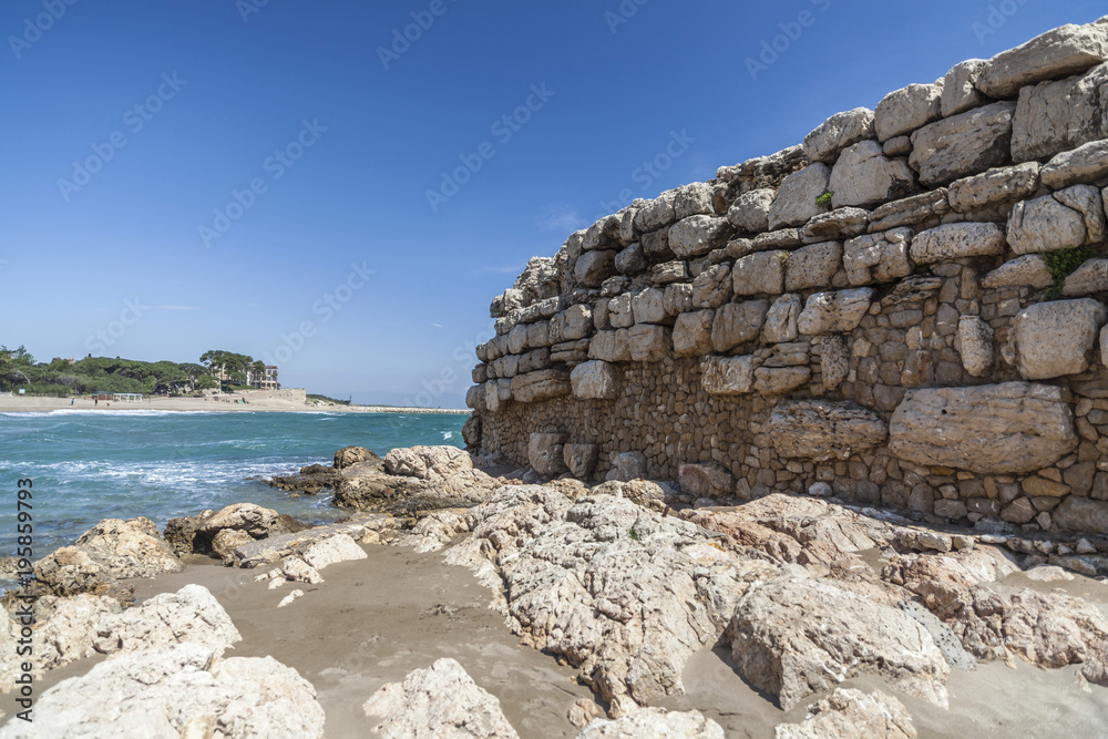 Ancient greek pier in beach of L Escala, Costa Brava, Catalonia, Spain.