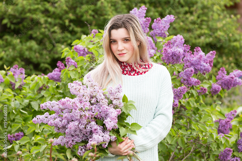 Beautiful young girl with a bouquet of lilacs in the garden Beautiful young girl with a bouquet of lilacs in the garden