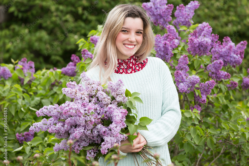 Beautiful young girl with a bouquet of lilacs in the garden Beautiful young girl with a bouquet of lilacs in the garden