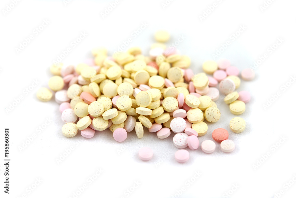 Multicolored round tablets on white background