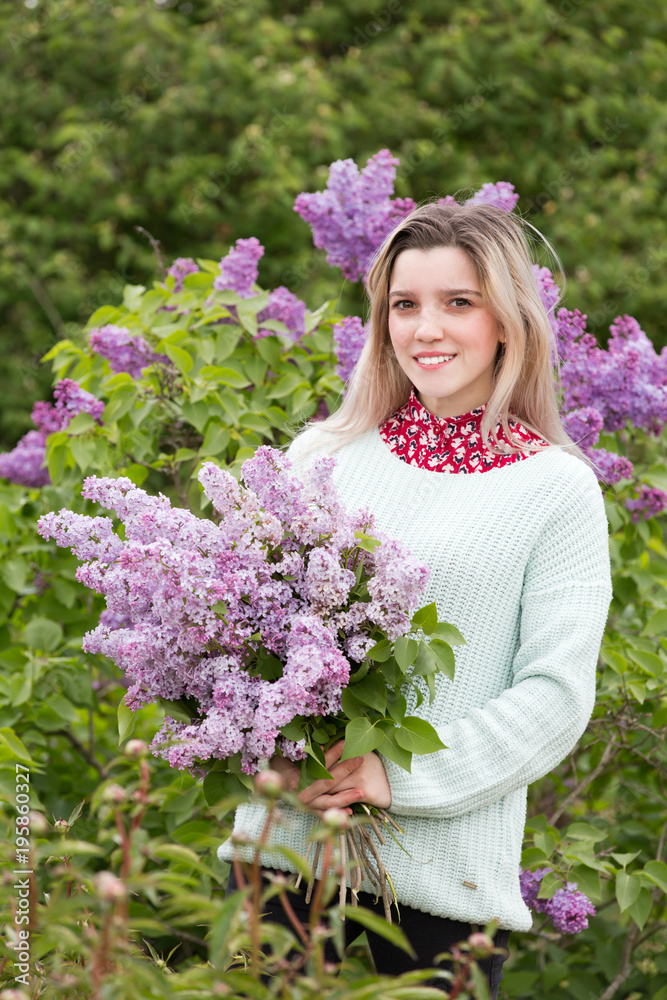 Beautiful young girl with a bouquet of lilacs in the garden Beautiful young girl with a bouquet of lilacs in the garden