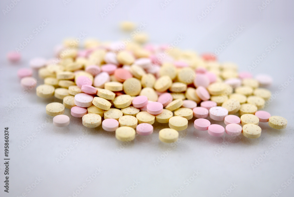 Multicolored round tablets on white background Multicolored round tablets on white background