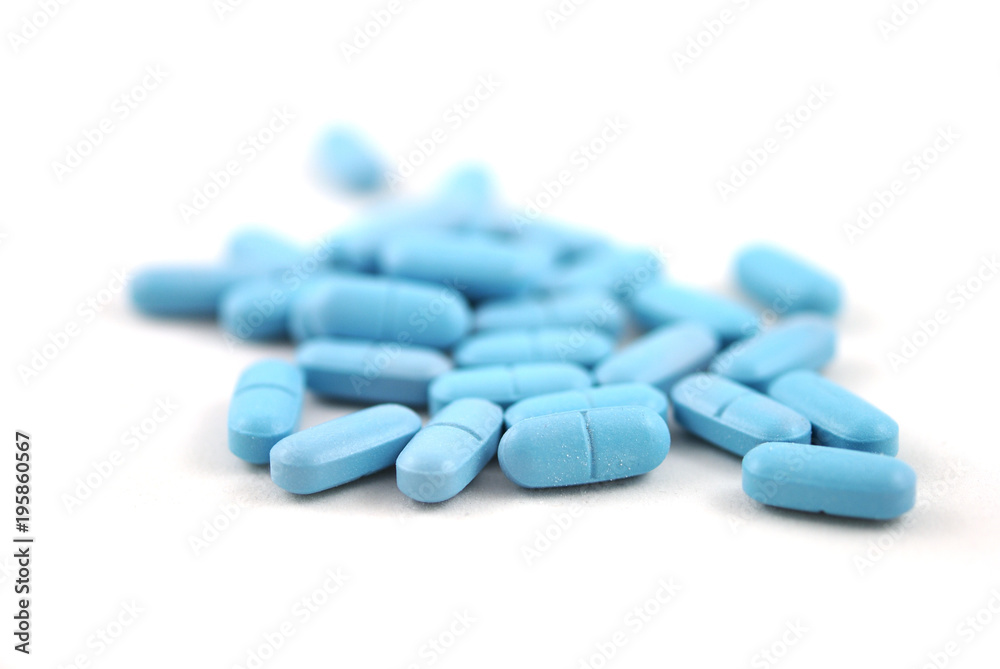 Blue oval tablets with reflection closeup on white background Blue oval tablets with reflection closeup on white background