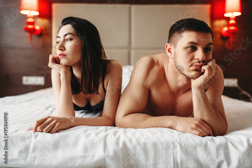 Love couple lies in bed, no sexual desire