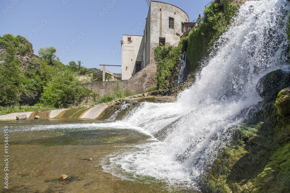 Village view, ancient water mill, moli fondo, and waterfall, Sant Joan les Fonts, Garrotxa, province Girona, Catalonia.Spain. Village view, ancient water mill, moli fondo, and waterfall, Sant Joan les Fonts, Garrotxa, province Girona, Catalonia.Spain.