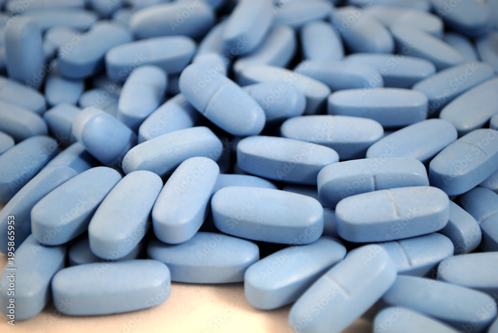 Big oval blue tablets closeup on white background Big oval blue tablets closeup on white background