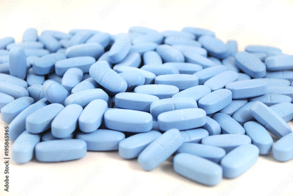 Big oval blue tablets closeup on white background Big oval blue tablets closeup on white background