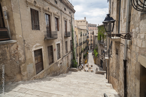 Street view, ancient buildings, stone stairs,historic center, Pujada de Sant Domenec or Escalinata de Sant Marti, Girona, Catalonia.Spain. photo