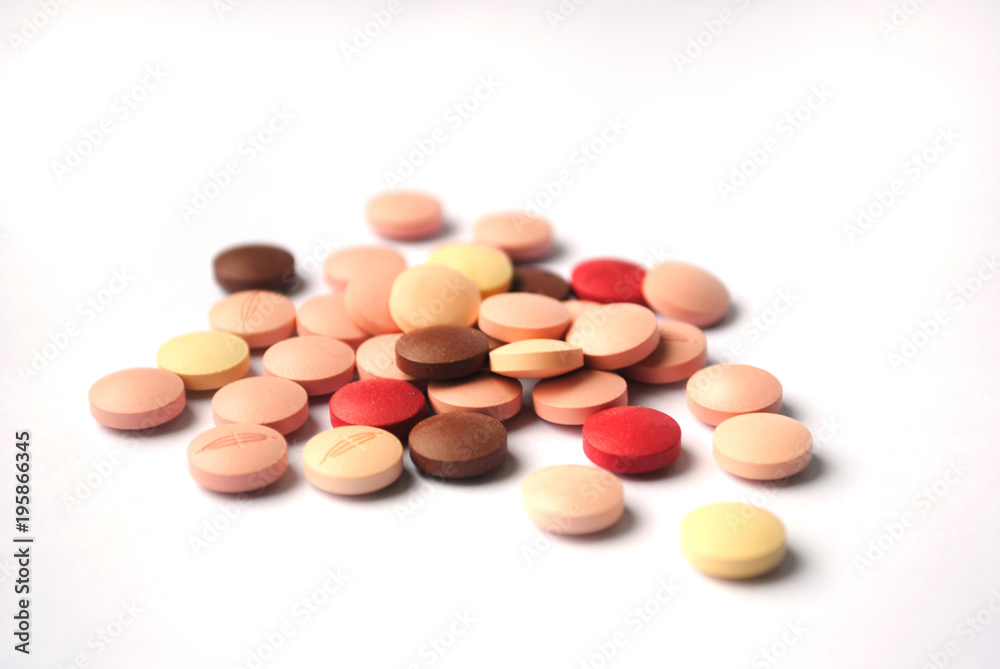 Multicolores bright tablets close-p on white backgroynd Multicolores bright tablets close-p on white backgroynd